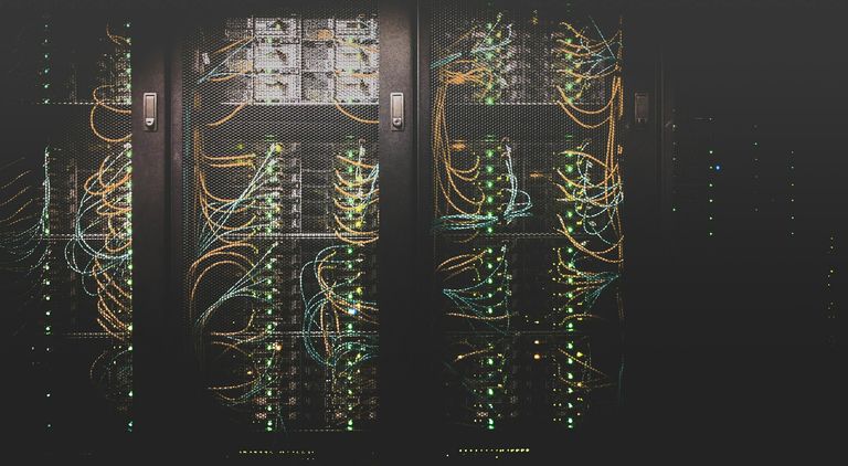 Server racks in a data centre with illuminated network cabling