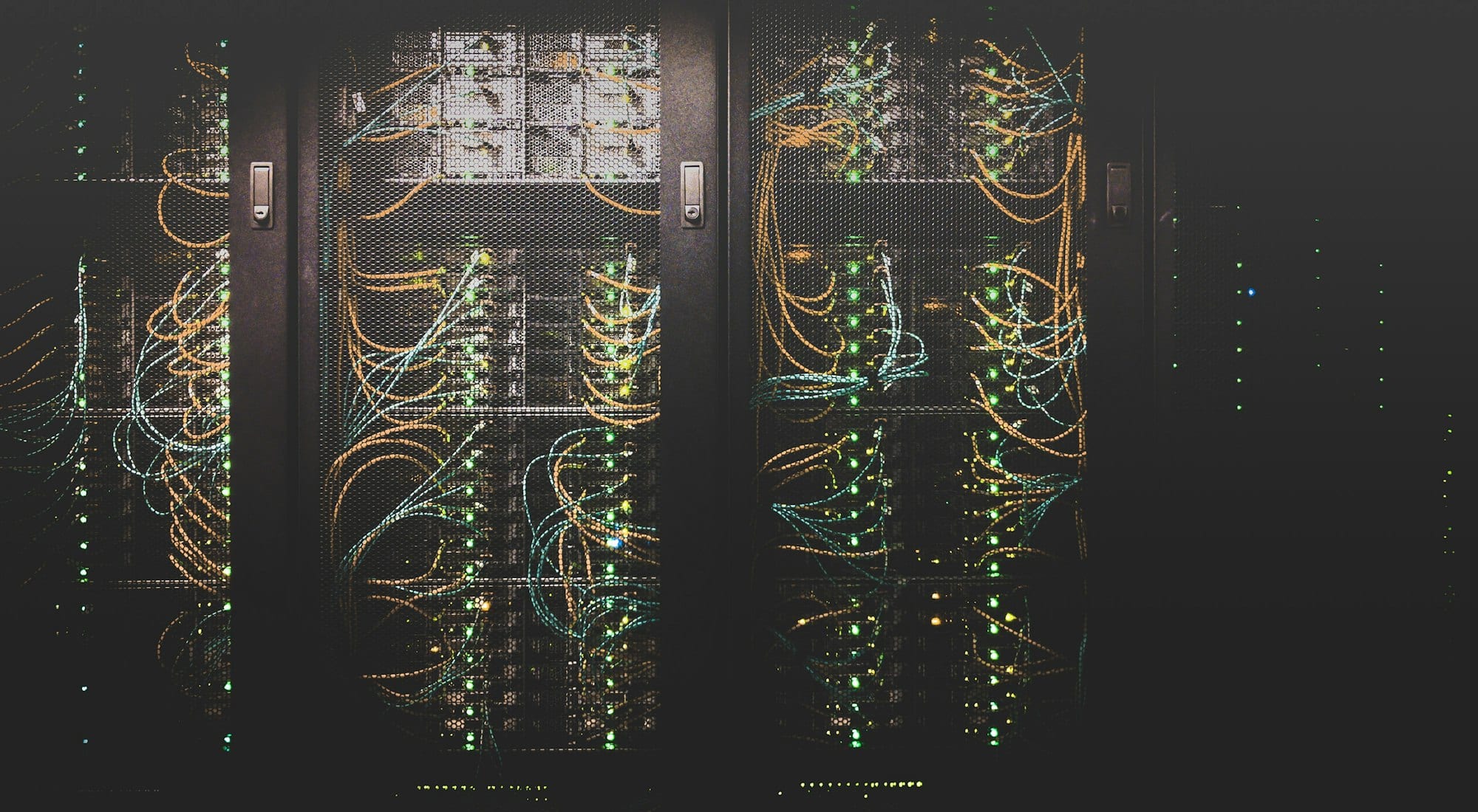 Server racks in a data centre with illuminated network cabling