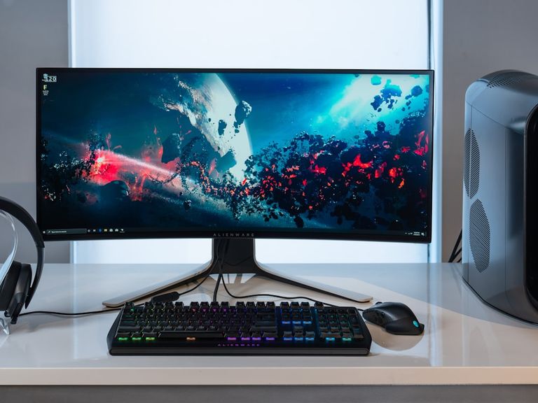 Ultrawide monitor and keyboard on a desk