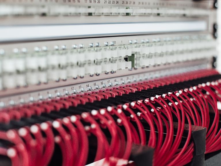 Network patch panel with red Ethernet cables