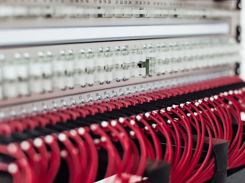 Network patch panel with red Ethernet cables