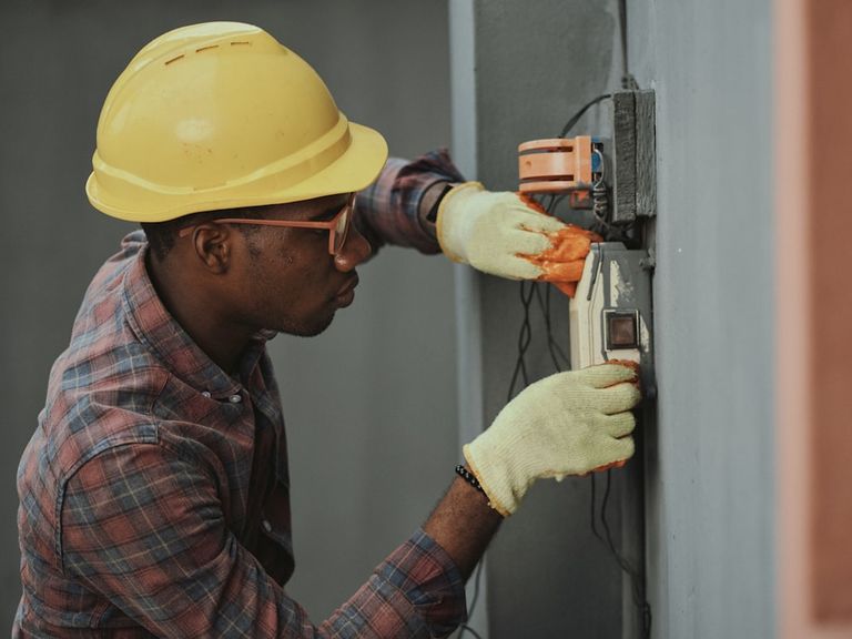 Technician working on electrical power equipment