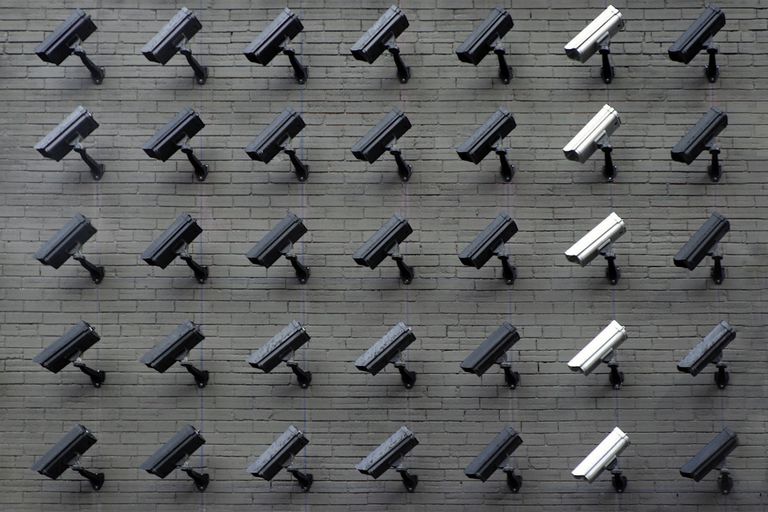 Array of surveillance cameras mounted on a wall