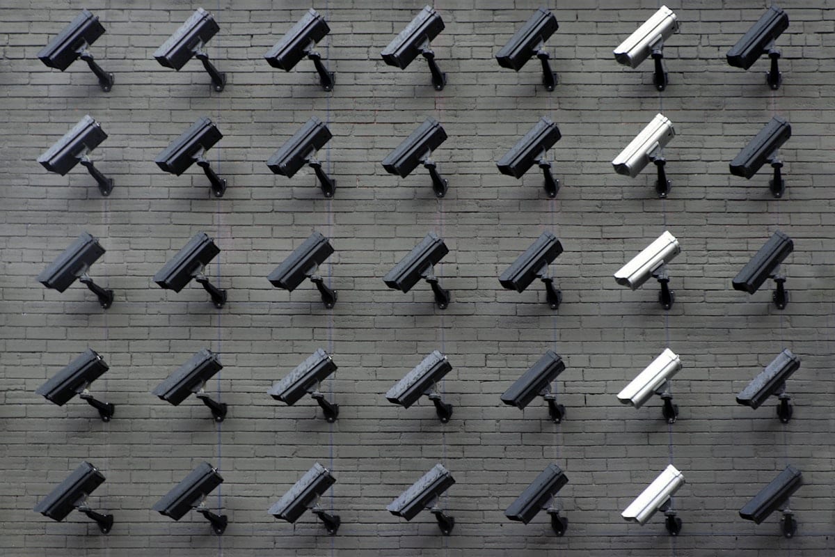 Array of surveillance cameras mounted on a wall